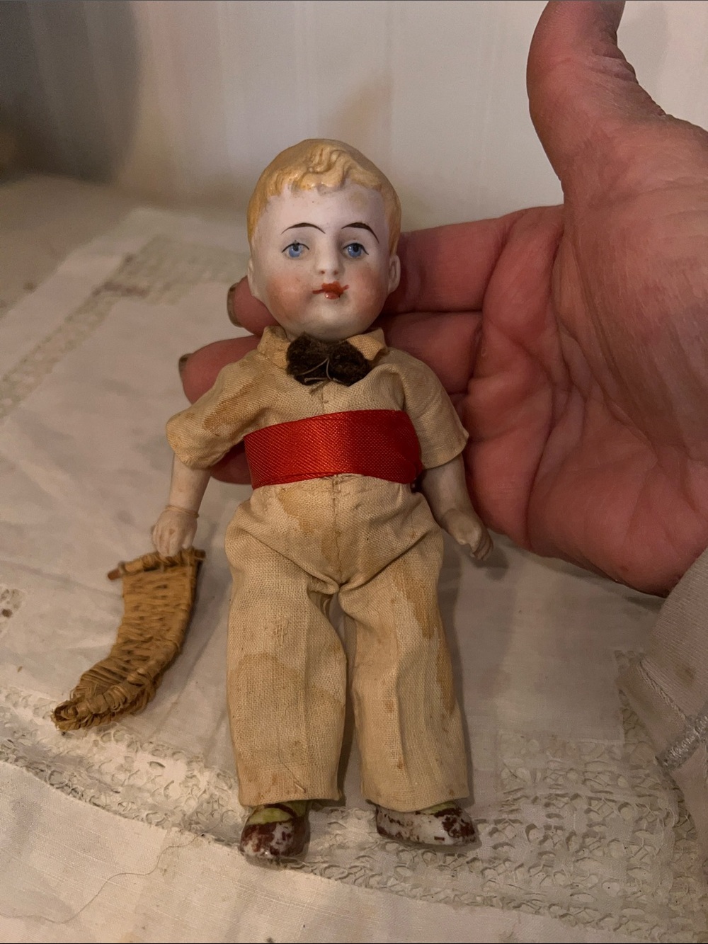 Antique German Bisque miniature boy doll holding basket